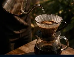 A pour over brewing into a glass carafe